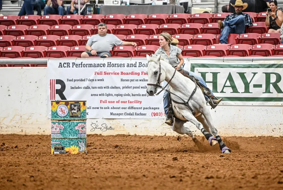 Young barrel racer and her horse